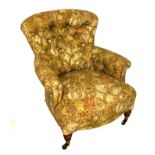 A VICTORIAN HOWARD STYLE BUTTON BACK UPHOLSTERED ARMCHAIR Floral style fabric covering and raised on