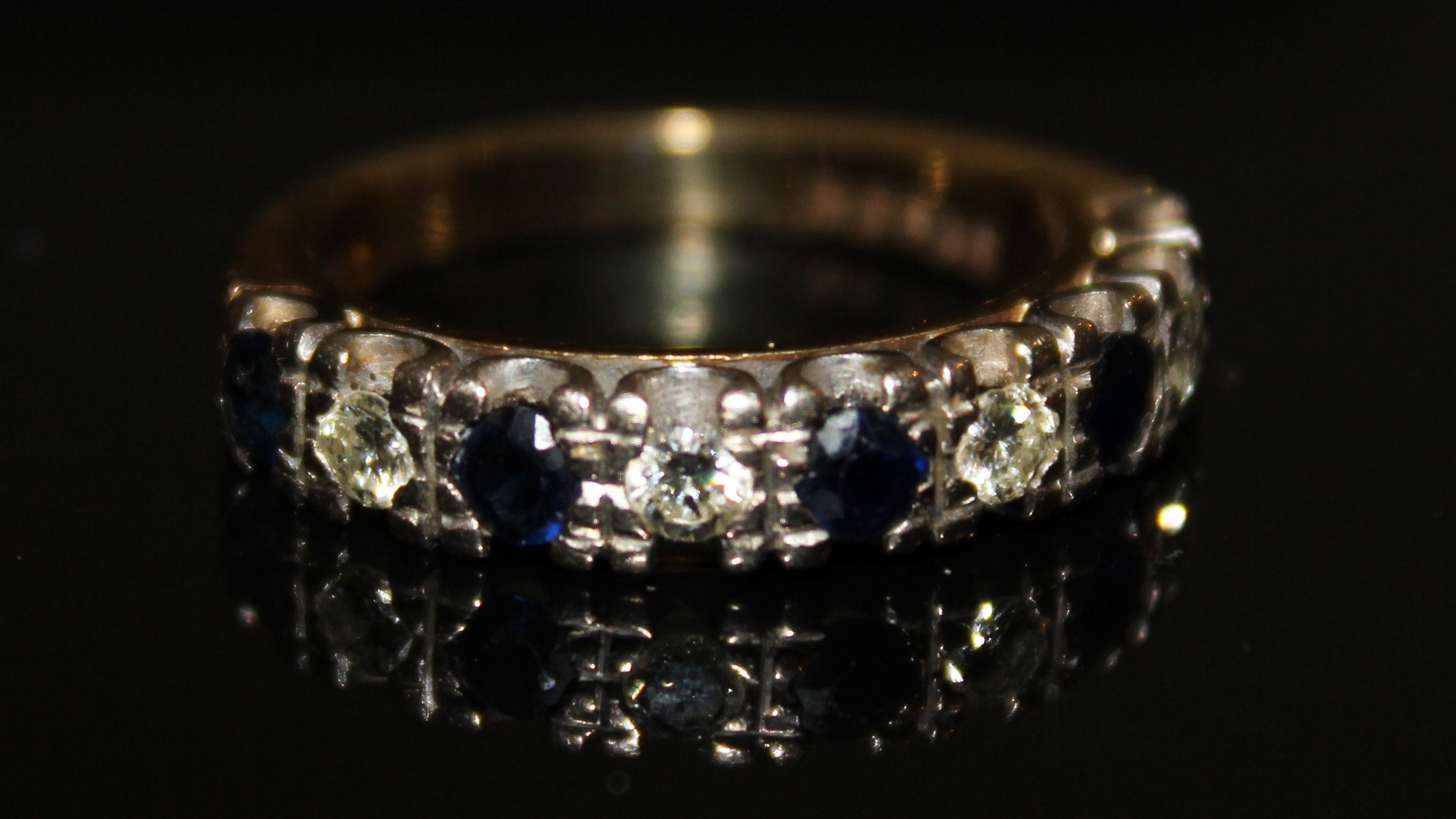 AN 18CT GOLD, SAPPHIRE AND DIAMOND HALF ETERNITY RING Having five round cut sapphires interspersed