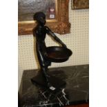 AN EARLY 20TH CENTURY CARVED EBONIZED WOOD BLACKAMOOR FIGURE Having single brass earrings and