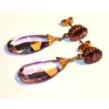 A VINTAGE PAIR OF YELLOW METAL AND AMETHYST DROP EARRINGS Set with two oval faceted stones with pear