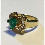 A 14CT GOLD, DIAMOND AND EMERALD RING Having a single cushion cut emerald flanked by baguette cut