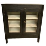 AN EARLY 20TH CENTURY EBONISED SIDE CABINET With two glazed doors.