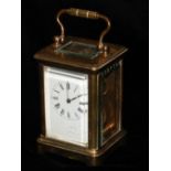 AN EARLY 20TH CENTURY GILT BRASS MINIATURE CARRIAGE CLOCK, Having four bevelled glass panels, a