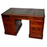 A VICTORIAN MAHOGANY DOUBLE PEDESTAL DESK Having a green leather top above an arrangement of