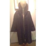 A VINTAGE DARK BROWN MINK FUR COAT With a sweeping collar, swing shaped and satin lined, bearing