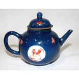 A KANGXI MINIATURE BLUE TEAPOT AND COVER Having iron red and gilt roundels of cockerels on white