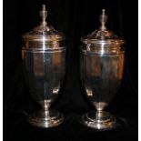 A CASED PAIR OF VINTAGE NEOCLASSICAL STYLE SILVER SUGAR CASTERS Having an urn shape finial and