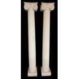 A PAIR OF CLASSICAL DESIGN CREAM PLASTER REEDED COLUMNS WITH IONIC CAPITALS. (252cm)