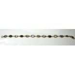 A VINTAGE 18CT GOLD AND GEM SET BRACELET Set with multicoloured oval cut stones, peridot,