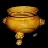 A 19TH CENTURY YELLOW GLAZED TRIPOD CENSER Having an ochre toned glaze, standing on a carved beast