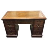 AN EDWARDIAN MAHOGAN PEDESTAL DESK With tooled tanned leather writing surface above arrangement of