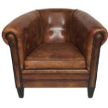 A TAN LEATHER UPHOLSTERED TUB ARMCHAIR With stud work. (75cm x 88cm x 75cm)