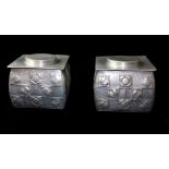 AFTER ARCHIBALD KNOX, A PAIR OF EARLY 20TH CENTURY ART NOUVEAU STYLE ALUMINIUM BISCUIT TINS With