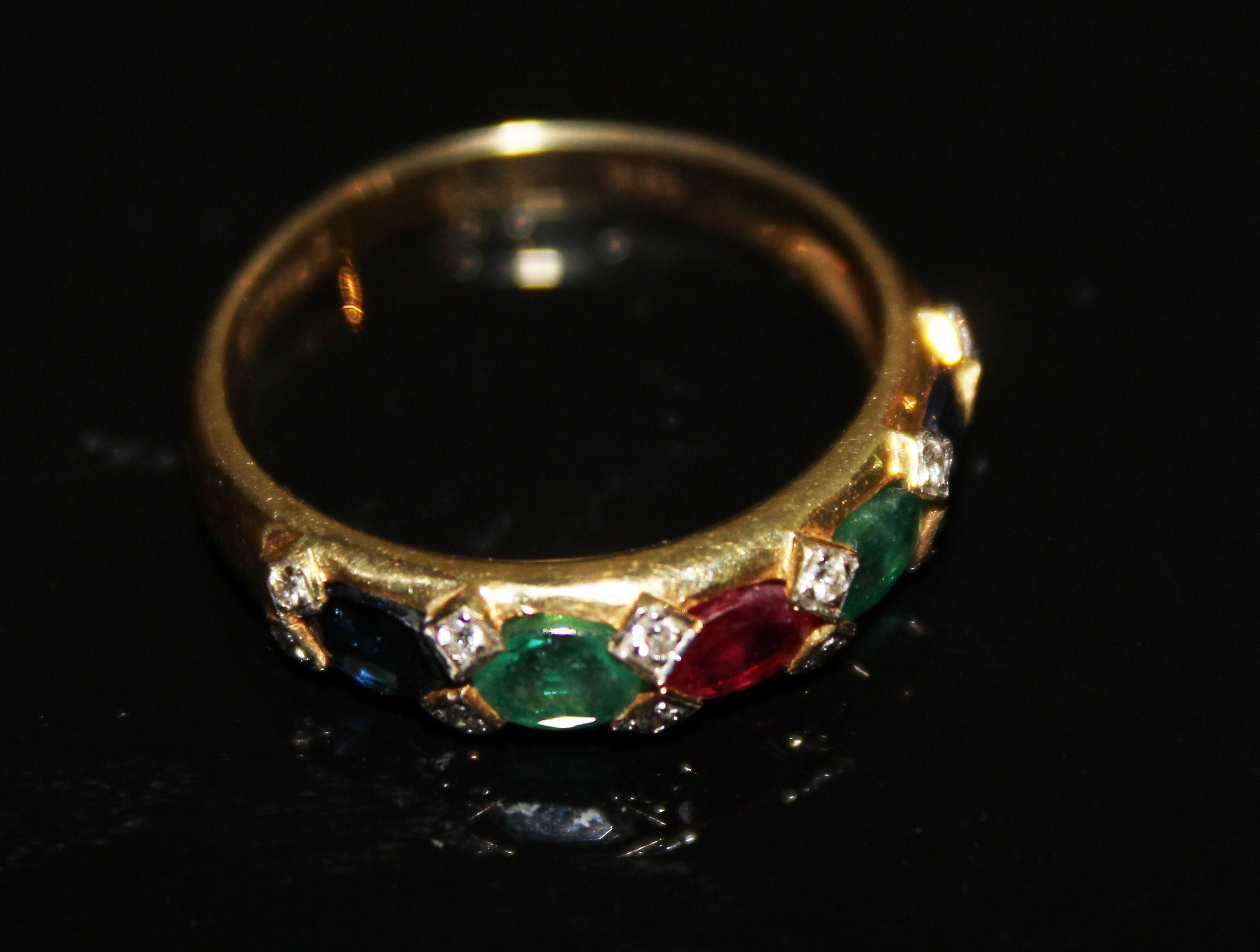 AN 18CT GOLD MULTI GEMSET FIVE STONE RING Comprising sapphires, emeralds and rubies spelling 'SERES'