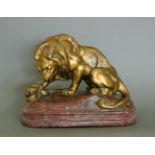 A LATE 19TH/EARLY 20TH CENTURY LION WITH SERPENT SCULPTURE CAST. (h 38cm x w 29cm x d 29cm)