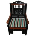 A 20TH CENTURY EBONISED MOORISH INSPIRED MARRIAGE CHAIR Of large proportions, having a pierced