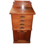 AN EDWARDIAN WALNUT PEDESTAL MUSIC CABINET With four fall front doors above cupboard. (52cm x 41cm x