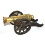 AN 18TH/19TH CENTURY BRASS BARREL STARTING CANNON On a steel carriage. (26cm) Condition: very good