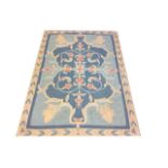 TWO 20TH CENTURY WOOLLEN RUGS Blue ground with floral central field decorated with grapes and