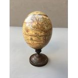 AN EARLY 20TH CENTURY MOUNTED OSTRICH EGG Decorated with a map of the world. (h 21cm x w 10.5cm x