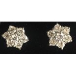 A PAIR OF 18CT WHITE GOLD SET DAISY CLUSTER EARRINGS. (approx 1.4ct)