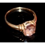 A VINTAGE 14CT GOLD AND AMETHYST RING Having a single oval cut faceted stone set in a plain gold