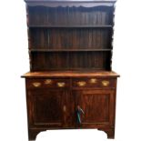 AN EARLY 20TH CENTURY GEORGIAN STYLE OAK DRESSER With open plate rack above two short drawers and