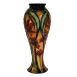 MOORCROFT, A LIMITED EDITION TUBELINED BALUSTER POTTERY VASE Having red floral decoration, signed to