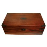 A VICTORIAN MAHOGANY AND BRASS WRITING SLOPE Having brass corners, carry handles and escutcheon,