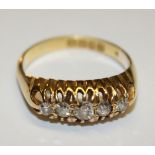 A VINTAGE 18CT GOLD AND DIAMOND FIVE STONE RING The tapering stones held in a claw set mount (size