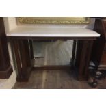 A PAIR OF FRENCH MAHOGANY EMPIRE DESIGN MIRRORED BACK CONSOLE TABLES The stone top supported on