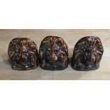 STAFFORDSHIRE, A SET OF THREE 19TH CENTURY TREACLE GLAZED WINDOW STAYS Formed as lion masks.