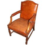 A 19TH CENTURY MAHOGANY OPEN ARMCHAIR With leather upholstery and shaped arms,