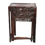 AN ORIENTAL ROSEWOOD NEST OF TABLES Carved faux bamboo frame set with pierced side panels. (approx