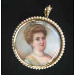 AN EARLY 20TH CENTURY 15CT GOLD AND PEARL DOUBLE SIDED LOCKET Set with a portrait of a lady, a black