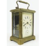 A 20TH CENTURY GILT BRASS CARRIAGE CLOCK Having four bevelled glass panels and a subsidiary dial,