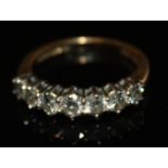 A VINTAGE 18CT GOLD AND DIAMOND SEVEN STONE RING Set with graduating round cut diamonds held in a