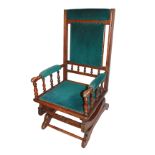 A LATE 19TH CENTURY AMERICAN WALNUT UPHOLSTERED ROCKING CHAIR With spindle back and arms.