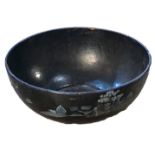 A LARGE PAPIER MACHÉ BOWL Bearing transfer printed blue willow pattern design on a black ground. (