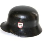 AN AUSTRIAN SATIN BLACK PAINTED HELMET With two decals having been partially erased, chinstrap and