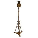 A 19TH CENTURY BRASS STANDARD OIL LAMP Raised on a tripod base. (h 142cm)