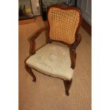 A 19TH CENTURY FRENCH MAHOGANY CANE BACK OPEN UPHOLSTERED ARMCHAIR Raised on cabriole legs.