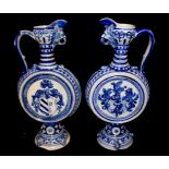 A PAIR OF EARLY 20TH CENTURY GERMAN POTTERY MOONFLASK EWERS Westerwald style with cobalt blue