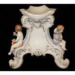 MEISEEN, A 19TH CENTURY PORCELAIN ROCOCO STYLE WINE BARREL BASE With three cherubs seated on