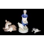 ROYAL COPENHAGEN, THREE 20TH CENTURY PORCELAIN FIGURINES A young girl with a goose, a recumbent deer