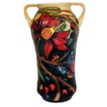 MOORCROFT, A TUBELINED TWIN HANDLED BALUSTER POTTERY VASE With floral decoration, signed to base '