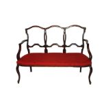 A 19TH CENTURY MAHOGANY BEDROOM SETTEE The carved back over upholstered seat and raised on