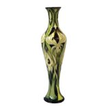 MOORCROFT, A LIMITED EDITION SLENDER TUBELINED POTTERY VASE Decorated with stylized yellow