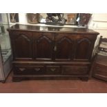 AN 18TH CENTURY OAK MULE CHEST (CONVERTED TO CUPBOARD) With fielded panels above three drawers,