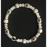 A VINTAGE 18CT WHITE GOLD BRACELET Encrusted with diamonds, pearls and sapphires.